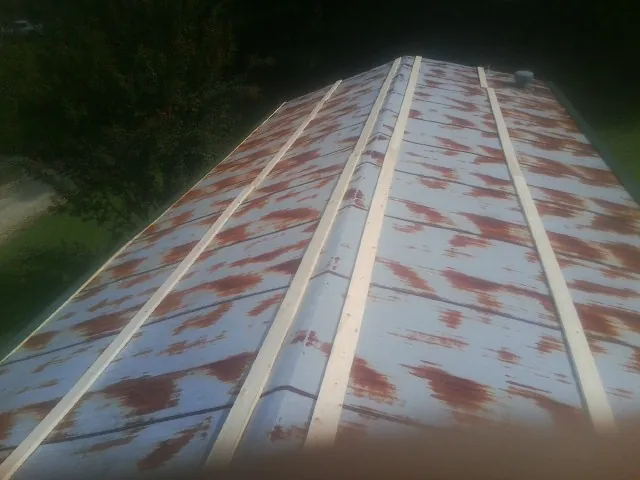 Rusted metal roof panels with new wood purlins before replacement — Storm Damage Roof Repair in Ellenville by Roofing Brothers
