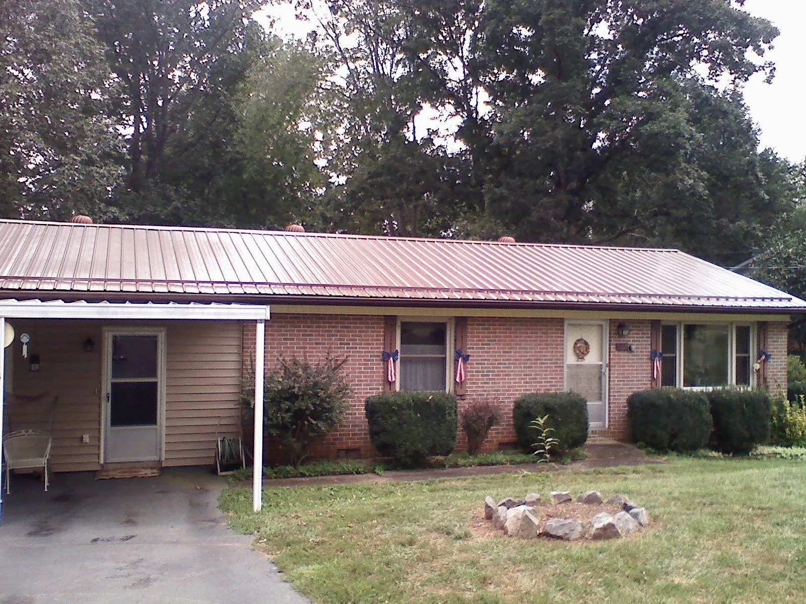 Bronze metal roof and carport on a brick ranch home — Roof Repair work by our crew in Ellenville